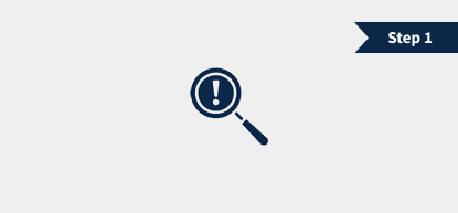 A magnifying glass with an exclamation mark