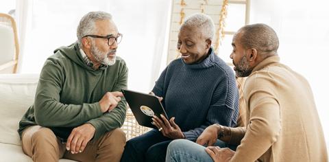  A group of people reviewing information on a tablet