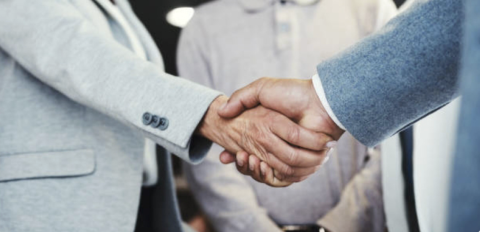  Close up of two business people shaking hands
