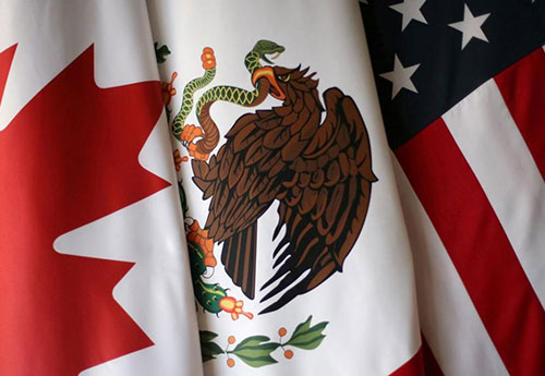 A close-up shot of the flags of Canada, Mexico, and the United States side by side.