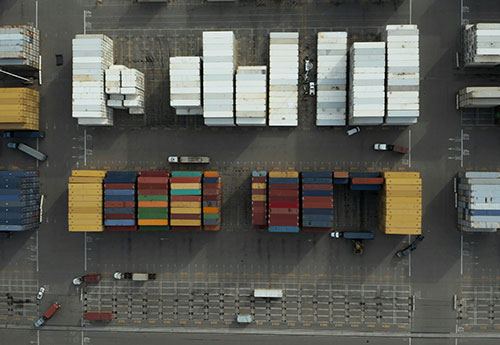 A bird’s eye view of colorful shipping containers. Photo by Tyler Casey for Unsplash.