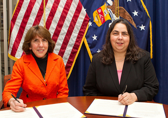 Beth Marks, NOND President, and ODEP Assistant Secretary Kathy Martinez, sign the Alliance agreement.