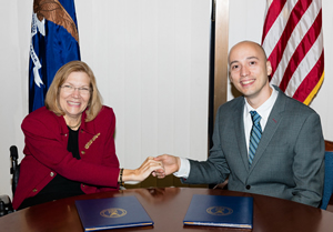 Jennifer Sheehy, ODEP Deputy Assistant Secretary, and Kenneth Matos, Senior Director of Research, Families and Work Institute, shake hands over the signed Allliance agreement.
