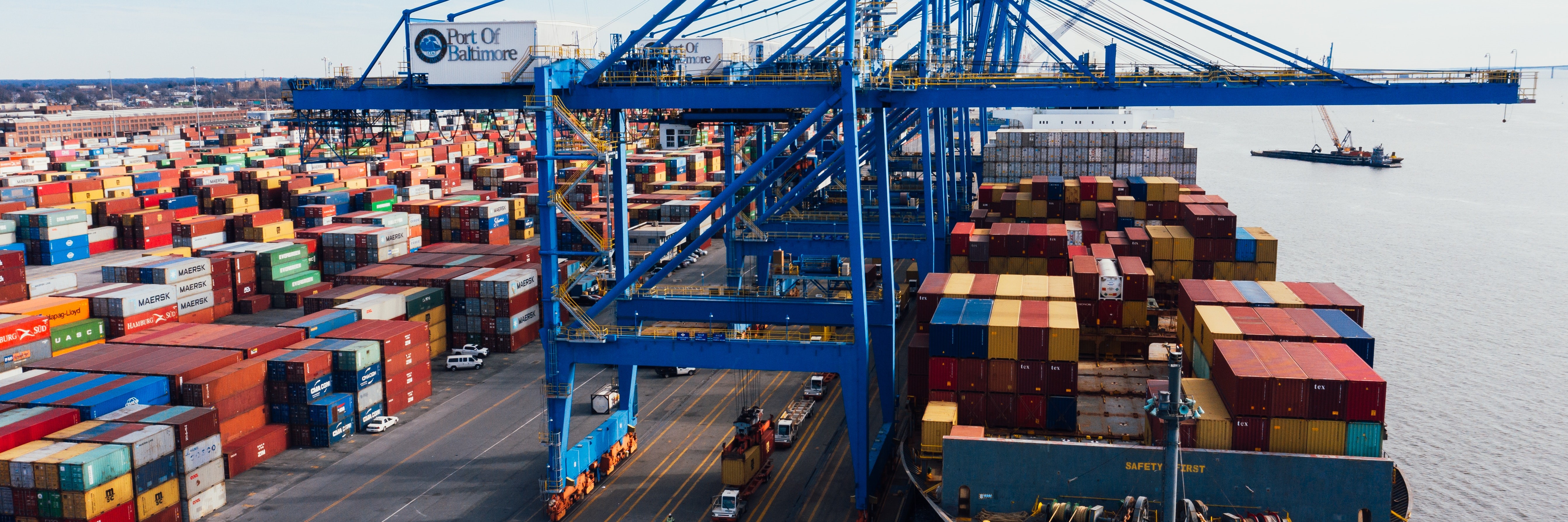 Cargo ship unloading red, blue and yellow containers