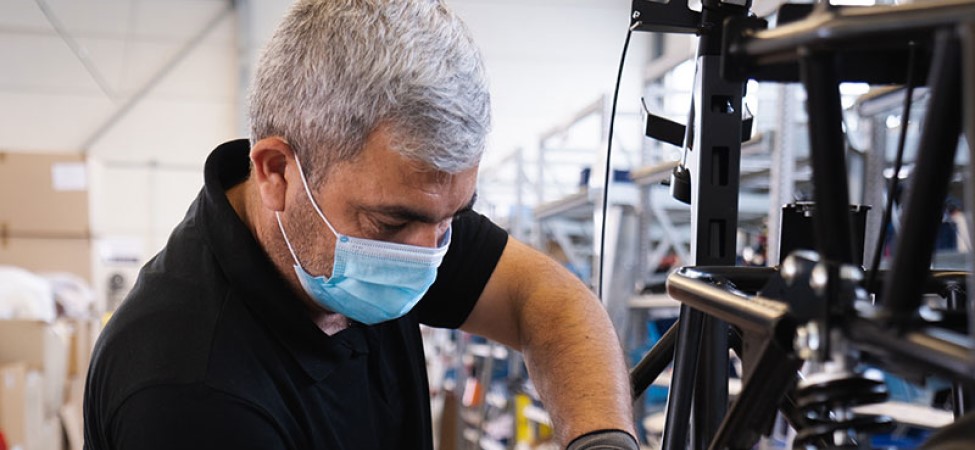 Man working in factory wearing a mask during COVID-19