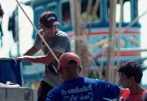 Workers unloading catch at Mahachai pier in Samut Sakhon, Thailand.