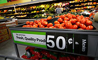 Tomatoes on display at a grocery store with a sign that read, “We promise fresh, quality produce, 50 cents per pound. Mexico”
