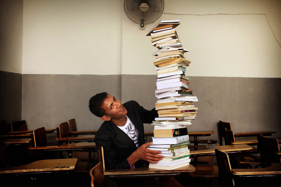 Mahmoud at a desk with books