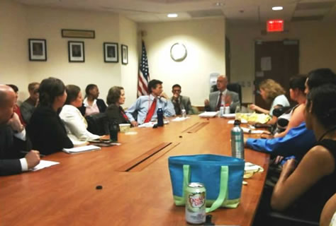 Image of a group of employees sitting around a large conference table