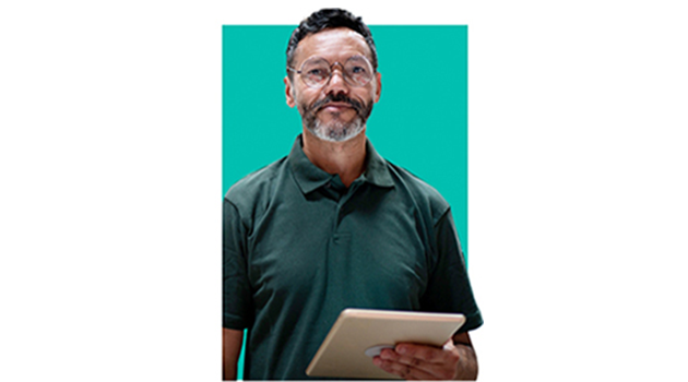 man with glasses holding a tablet