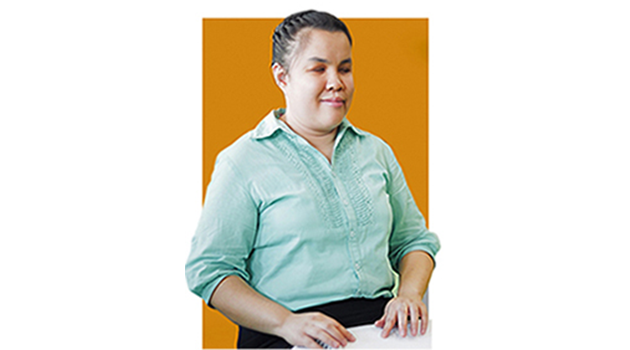 Young woman using her braille reader