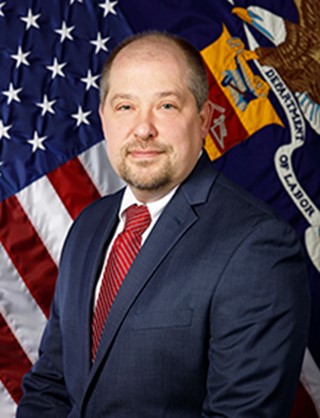 a pic of Brian in front of American flag