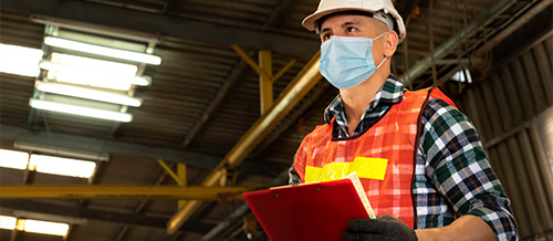 Worker wearing a face covering