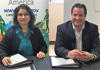 OSHA Lubbock Area Director Elizabeth Routh and Jason Smith of Lee Lewis Construction sign alliance to protect construction employees.