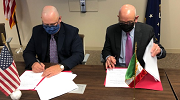 OSHAs Jeffrery Erskine (left) signs a worker protection agreement with the Consul General of Mexico in Boston.