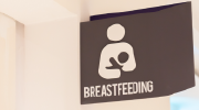 A sign marked breastfeeding identifies a designated nursing space. 