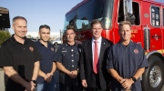 Secretary Walsh poses with firefighters in front of a fire engine.