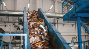 Recycling plant. Waste and recyclable materials move down a conveyor.