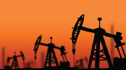 Oil pumps silhouetted against an orange sky. 