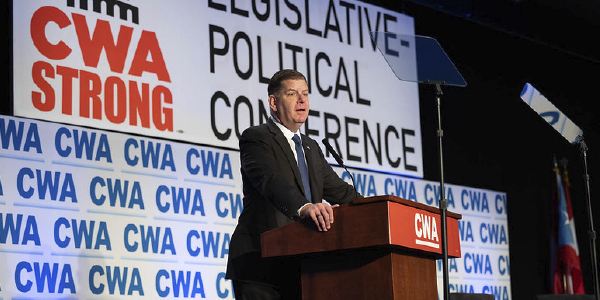 Secretary Walsh stands at a podium in front of a sign reading CWA Strong Legislative-Political Conference.