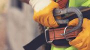 Close-up of a worker securing a safety harness.