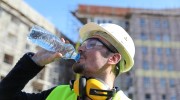 Construction worker drinks water. 