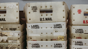 Photo of empty, stacked USPS boxes for carrying mail