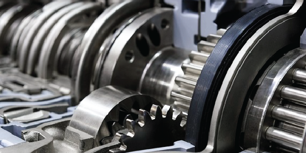 Close-up of industrial metal gears in a large machine.