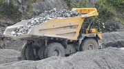 A large truck hauls rocks from a quarry.