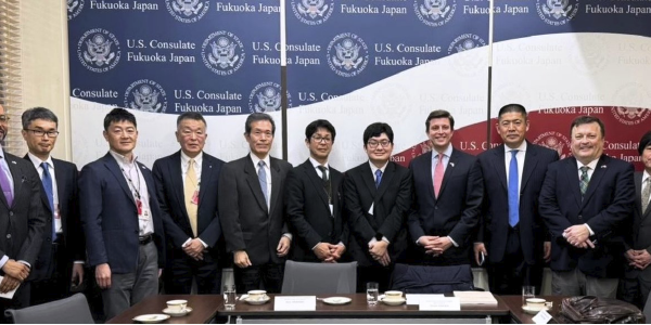 Brent Parton poses for a photo with 9 other men, all in suits, at the U.S. Consulate in Fukuoka, Japan.