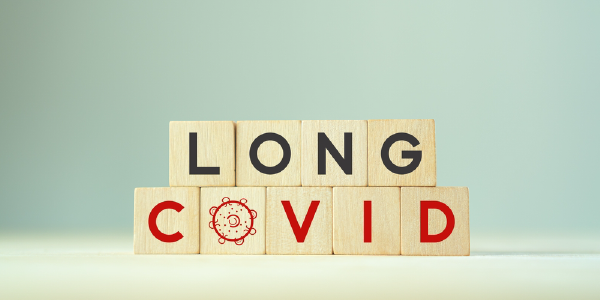 Wooden blocks arranged to spell out the phrase Long Covid