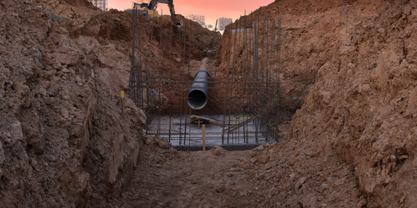 A trench for a sewer pipe at a construction site.