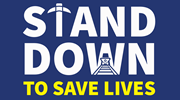 Stand Down to Save Lives logo featuring a pick ax for the letter “T” and a coal car inside of the “W”