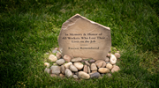 A memorial stone with an engraving that reads, “In memory and honor of all workers who lost their lives on the job.” 