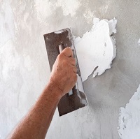 smoothing cement on a wall