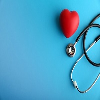  a blue background with a stethoscope and a red foam heart