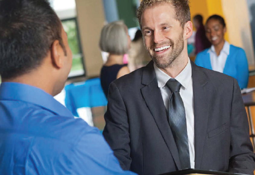 Two men shaking hands at job fair.