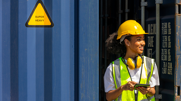 trades woman wearing a yellow safety vest