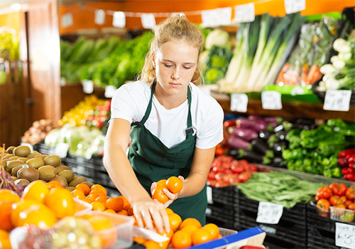 girl stocking produce