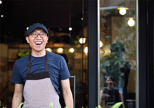 cheerful young guy greeting at retail