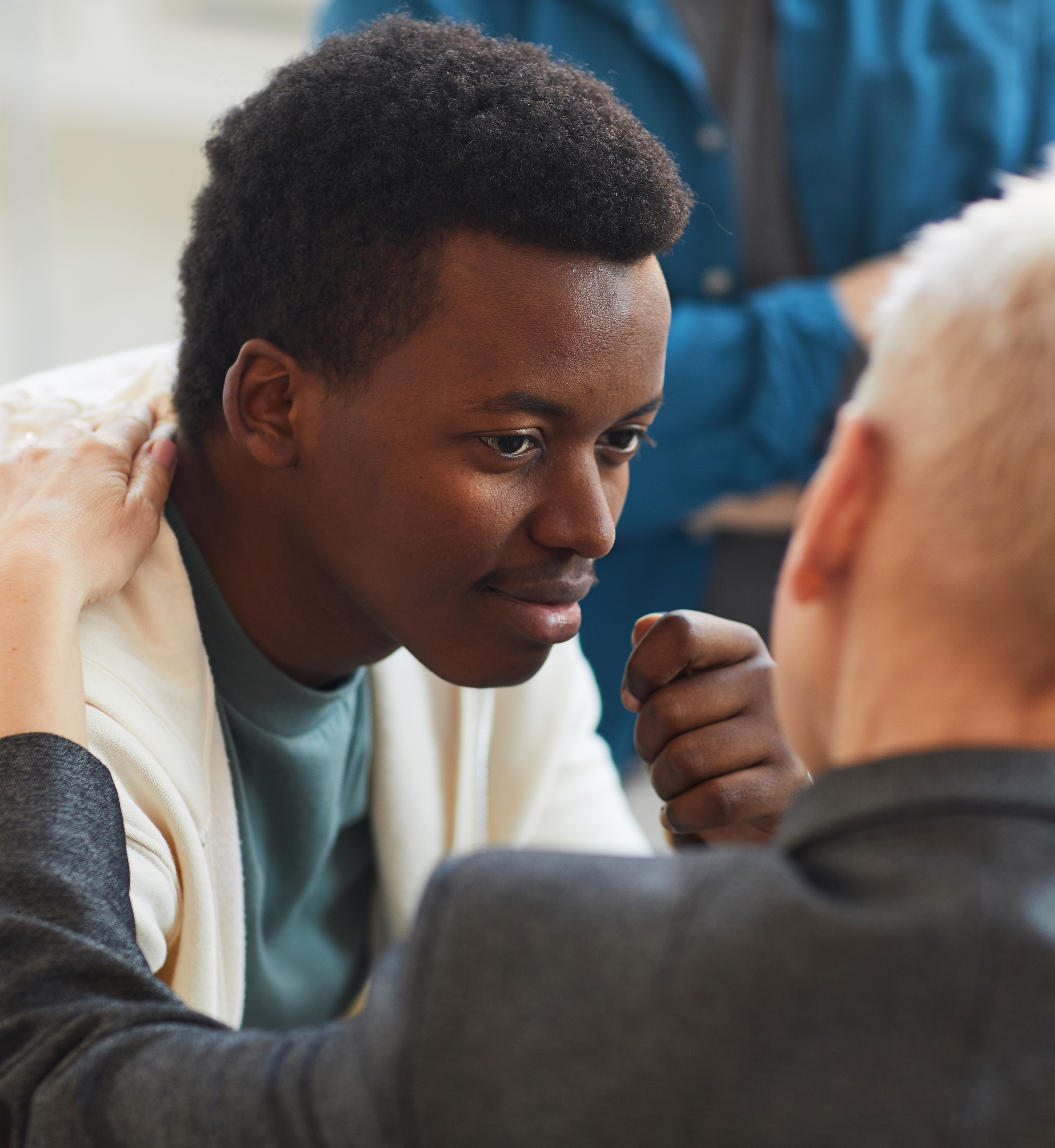 Man with a hand on his shoulder