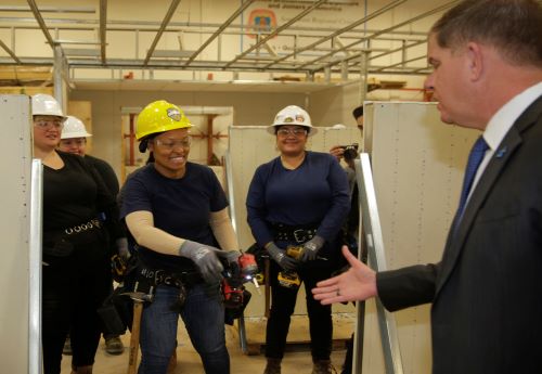 Labor Secretary Marty Walsh shaking hands with construction workers