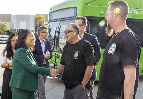 Acting Secretary Labor Secretary Julie Su shaking hands with construction workers