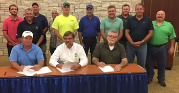 Joined by area masons (seated from left), Mason Contractors Association of St. Louis President Rick Swanson, OSHA St. Louis Area Director Bill McDonald, and Eastern Missouri Laborers’ District Council Business Manager Gary Elliott renew safety alliance.