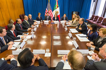 Representatives of the Mexican Secretariat of Labor and Social Welfare (left), the Mexican Embassy (left), and the U.S. Department of Labor (right) meet before a signing ceremony for joint declarations to inform Mexican workers about their labor rights under U.S. laws.
