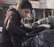 Qusai, 13, scavenges through trash in 'Jordan: Living on Scrap,' a Promising Futures documentary, funded by the U.S. Department of Labor.