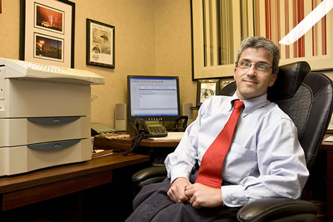 Image of a man at a desk in an office