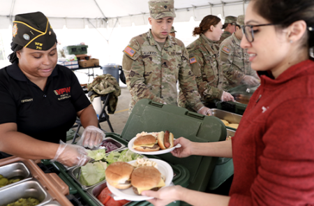 Veteran is serving food.